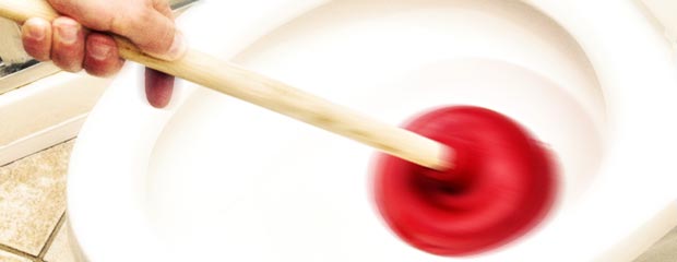 plunger clearing blocked toilet