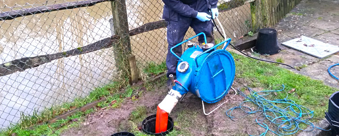 plumber working infront of a home in toronto performing a cured in place pipe drain repair service